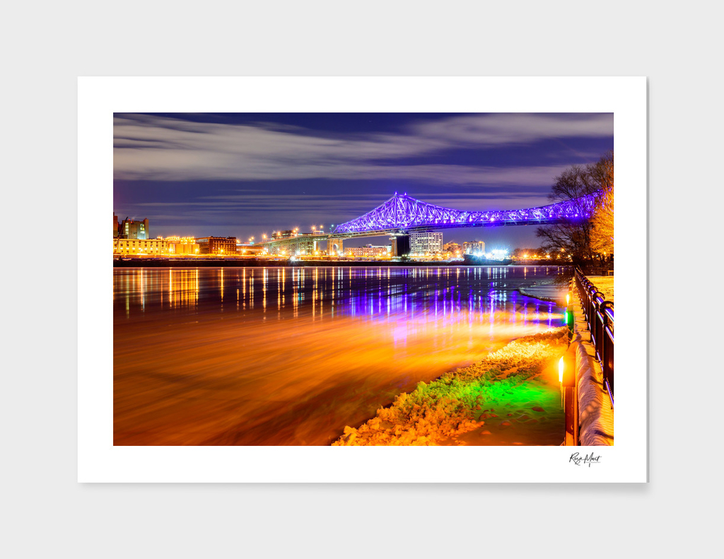 Illuminated bridge over river against the sky
