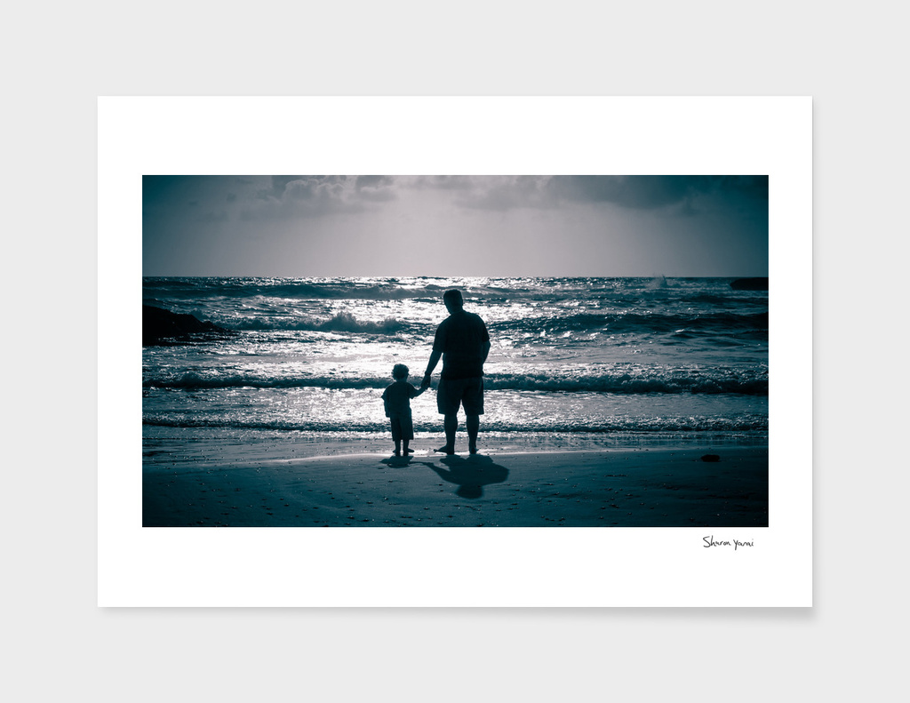 Father and Son on the beach at dusk