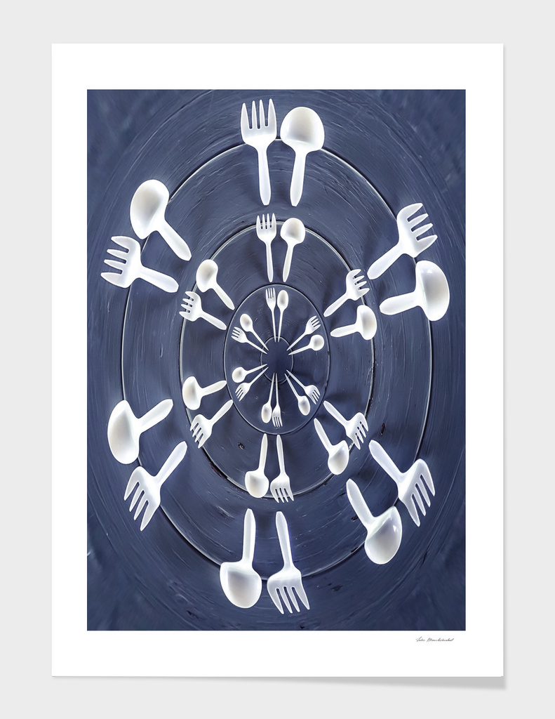 forks and spoons on the wooden table in circle pattern