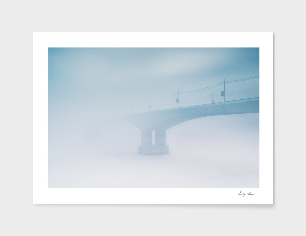 Bridge in winter fog on morning Russia