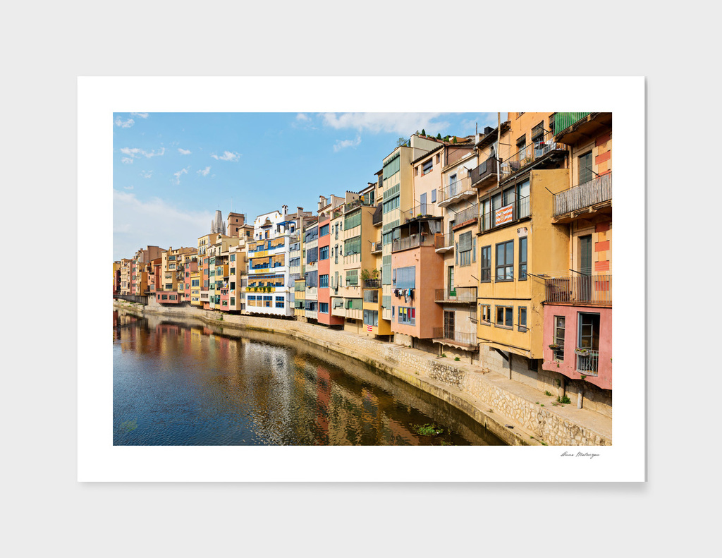 Colorful houses and reflected in water in Girona